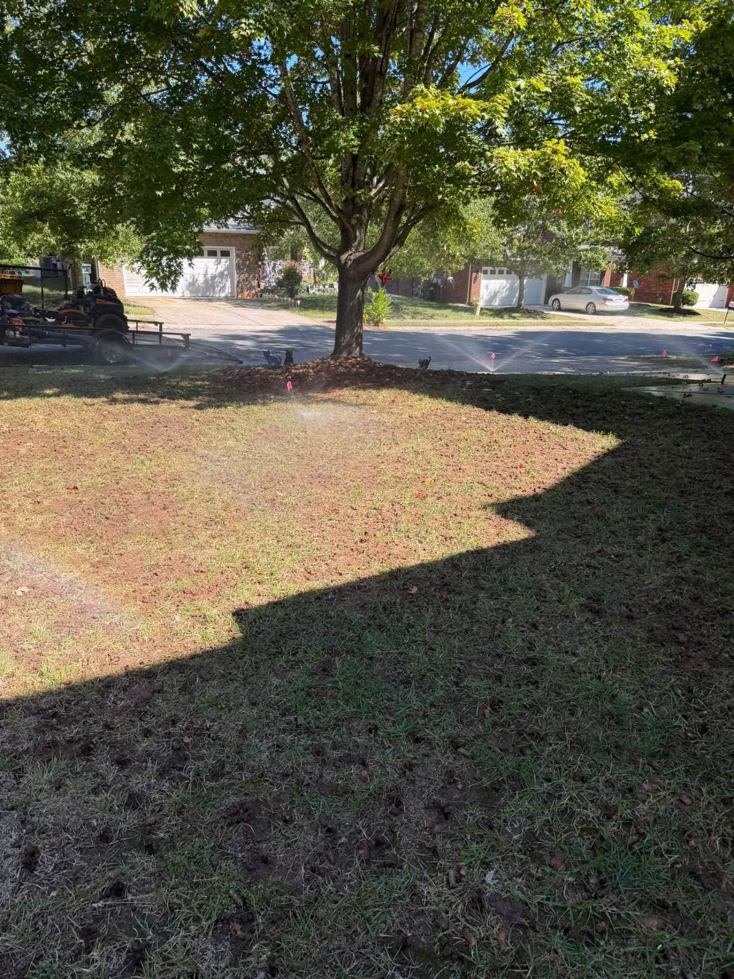 Front yard being watered after aeration and seeding